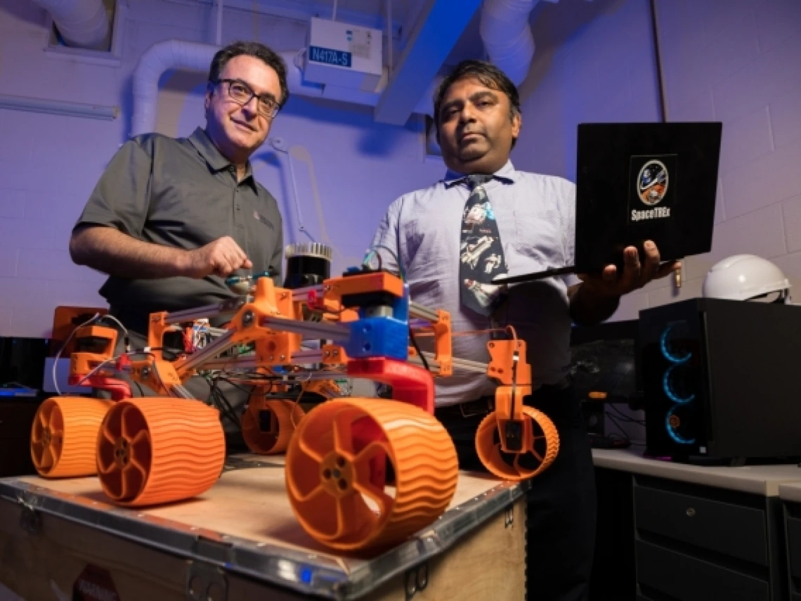 Jekan Thanga and Moe Momayez with a rover prototype